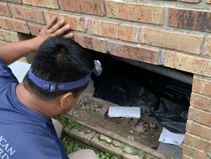 Foundation inspector looking for cracks or broken blocks.