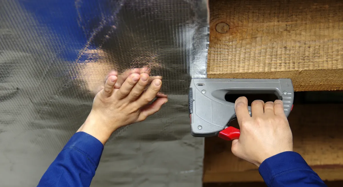 Moisture barrier being installed under the home's crawl space.