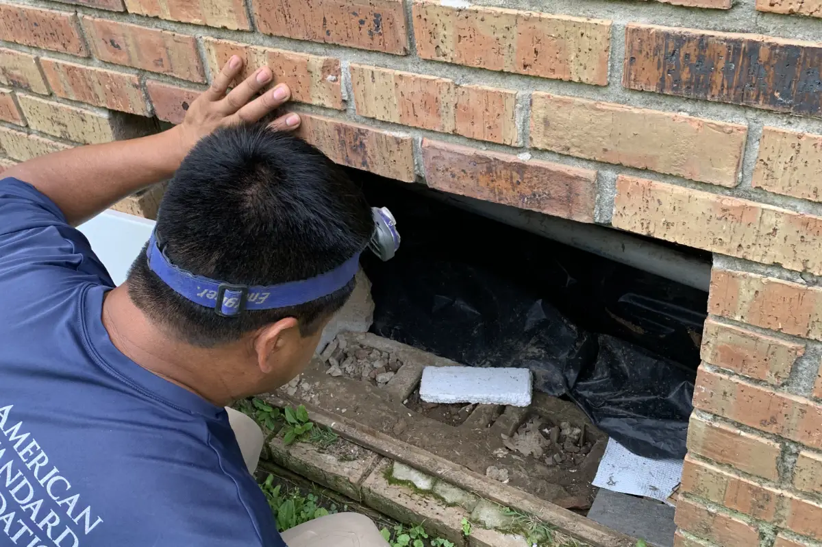 Foundation inspector looking for cracks or broken blocks.