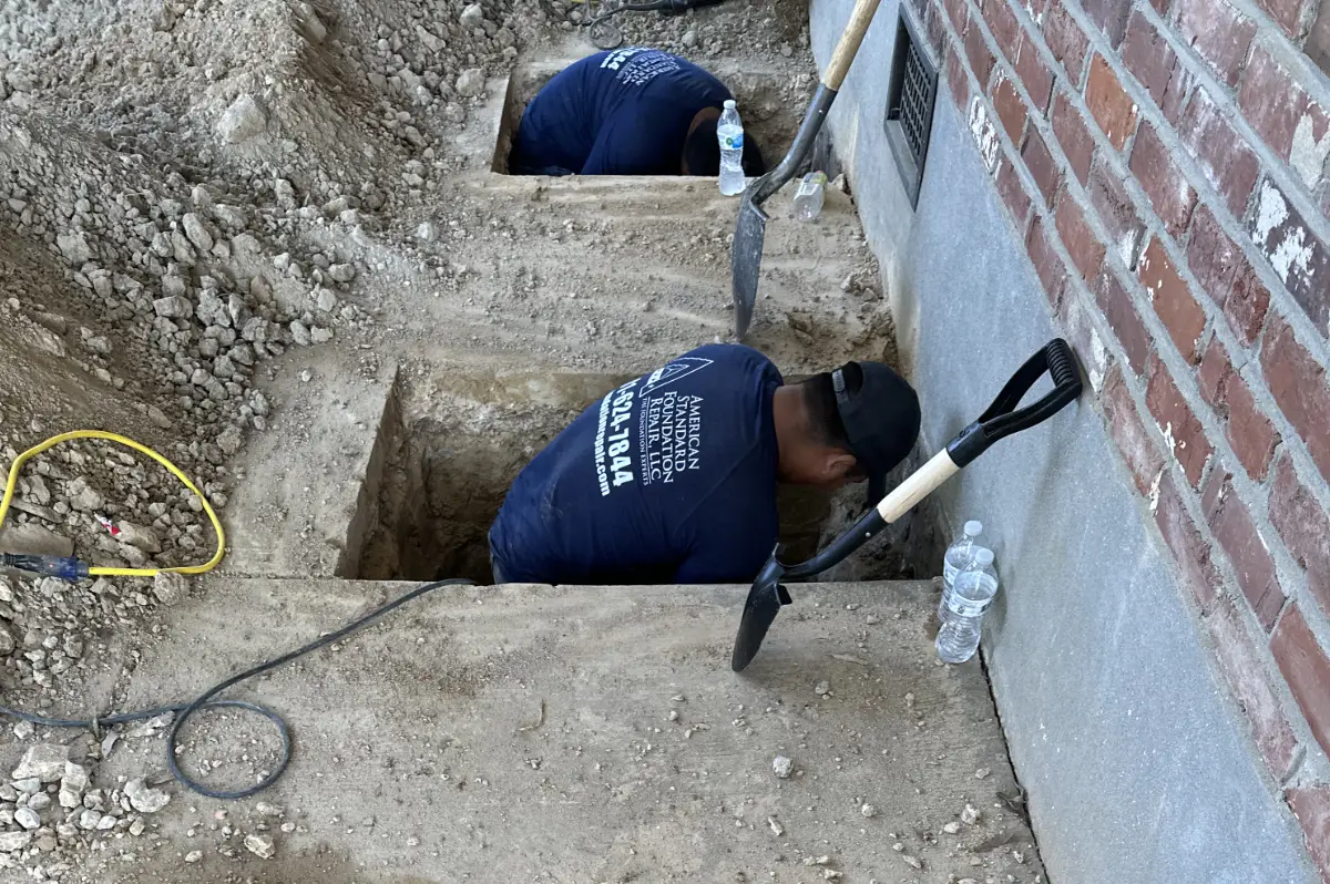 Digging though the foundation to repair cracks and stabilize.