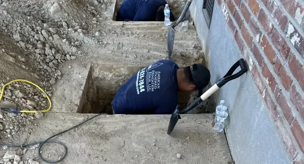 Diggin though the foundation to repair cracks and stabilize.
