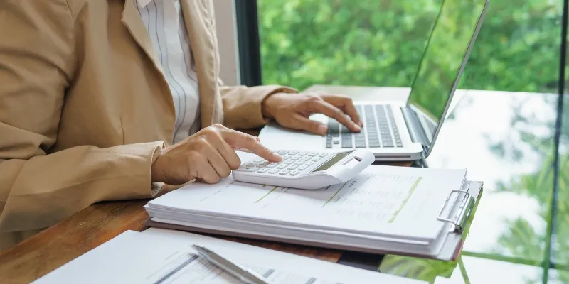 Person calculating bills.