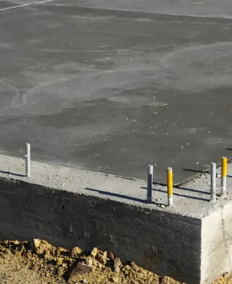 New industrial concrete slab sowing the footing with support rods.