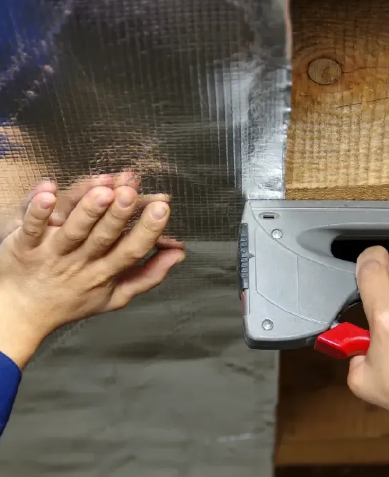 Moisture barrier being installed under the home's crawl space.