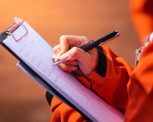 Crawlspace inspector taking notes.