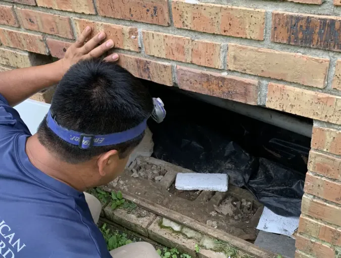 Foundation inspector looking for cracks or broken blocks.