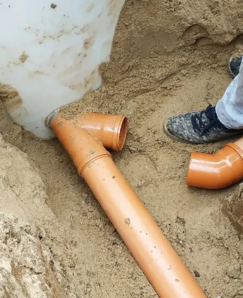 PVC being installed for diverting water away from foundation.