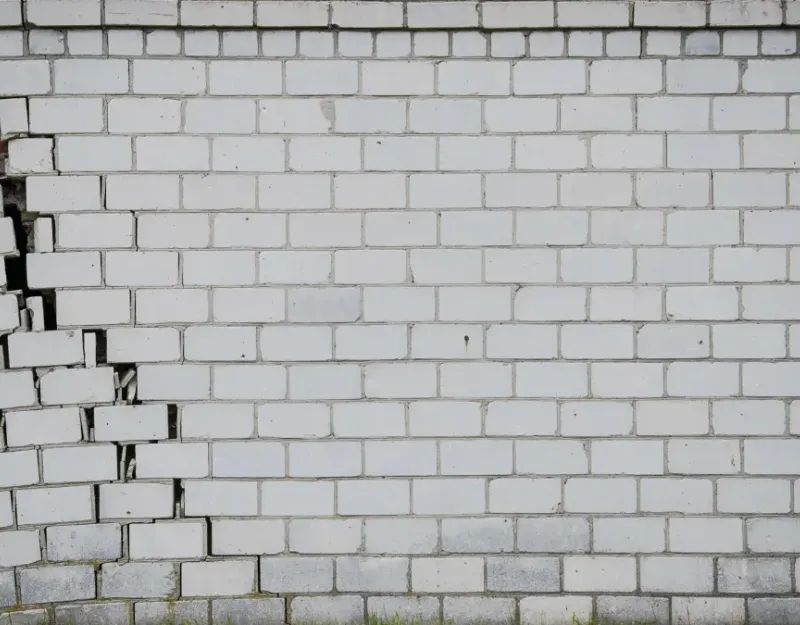 Brick wall falling off the foundation.