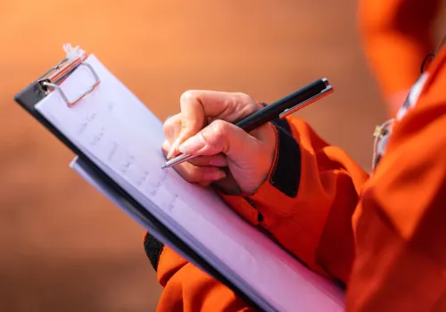 Crawlspace inspector taking notes.